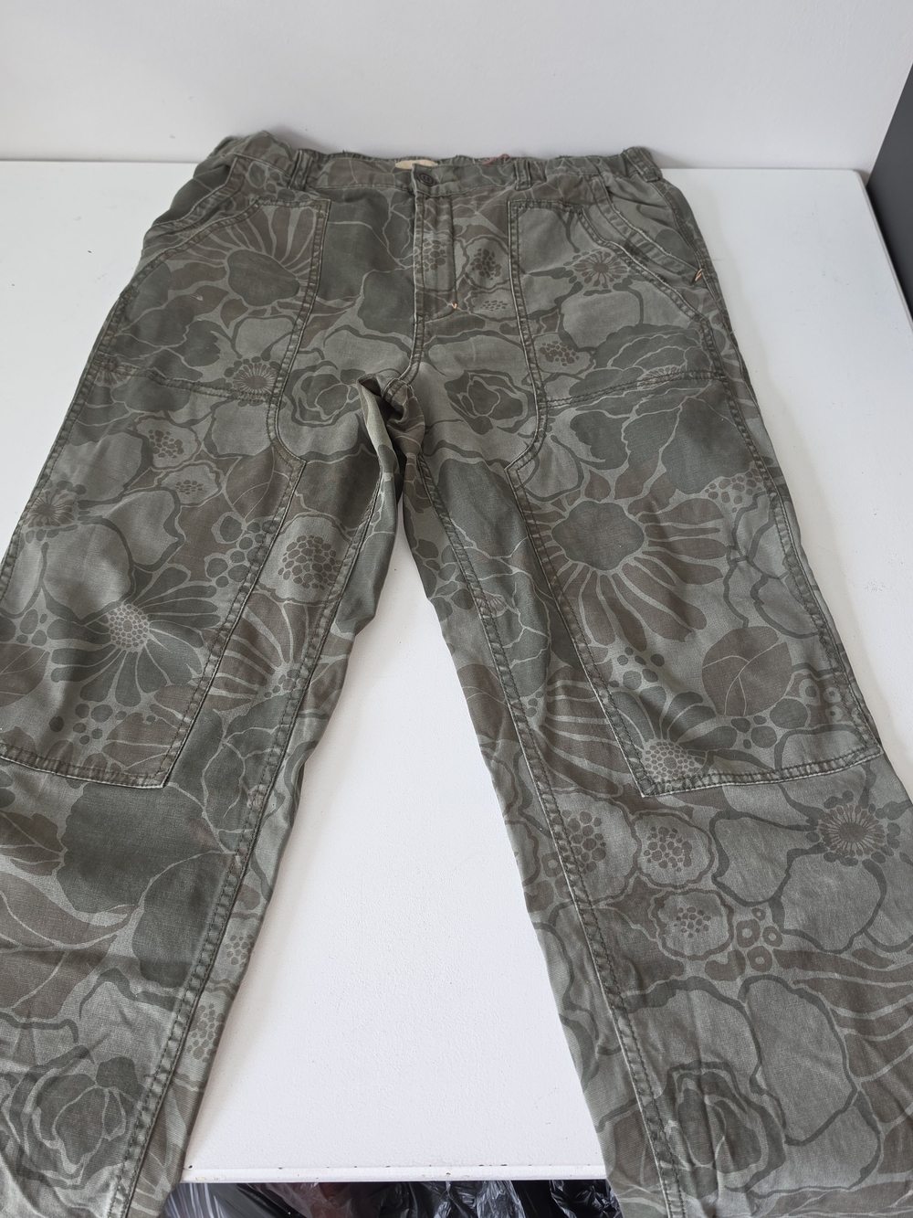Anthropologie Pilcro and the Letterpress olive green floral straight leg pants.